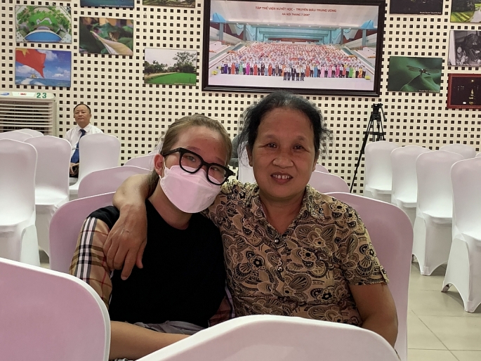 Bà Hồ Thị Kim Hương cùng cháu nội háo hức chờ đủ tuổi để tham gia hiến máu theo gương bố mẹ (ảnh T.A).