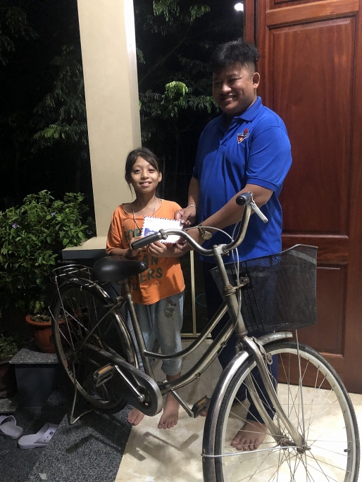 Anh Tưởng đại diện Đoàn xã tặng em học sinh mồ côi cha mẹ chiếc xe đạp và tiền mặt, san sẻ một phần khó khăn với gia đình em