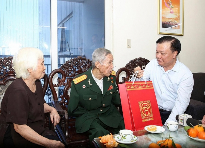 Bí thư Thành ủy Đinh Tiến Dũng trao quà tặng Anh hùng La Văn Cầu nhân kỷ niệm 79 năm Ngày thành lập Quân đội Nhân dân Việt Nam. Ảnh: Viết Thành