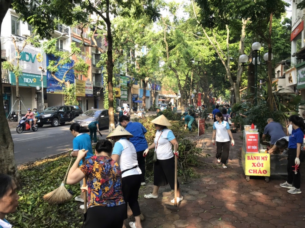 Cán bộ, phụ nữ quận Ba Đình cùng lực lượng thu gom miệt mài dọn dẹp vệ sinh, rác thải trên các tuyến phố. Ảnh: Thu Hồng