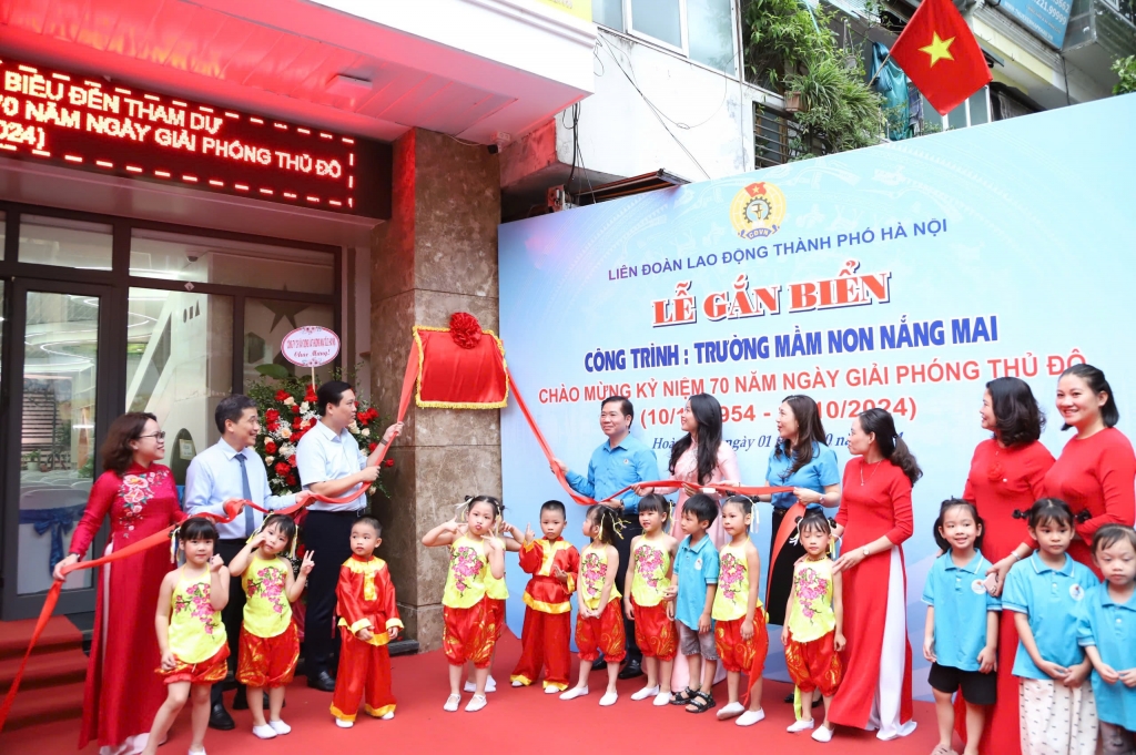 Các đại biểu thực hiện nghi thức gắn biển công trình trường Mầm non Nắng Mai chào mừng kỷ niệm 70 năm Ngày Giải phóng Thủ đô