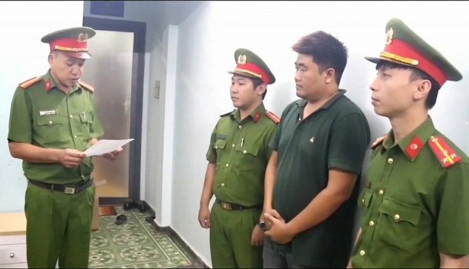 Nguyễn Lâm Minh Tuấn nghe cảnh sát đọc lệnh tạm giữ khẩn cấp, Ảnh: CACC Nguyễn Lâm Minh Tuấn nghe cảnh sát đọc lệnh tạm giữ khẩn cấp, Ảnh: CACC