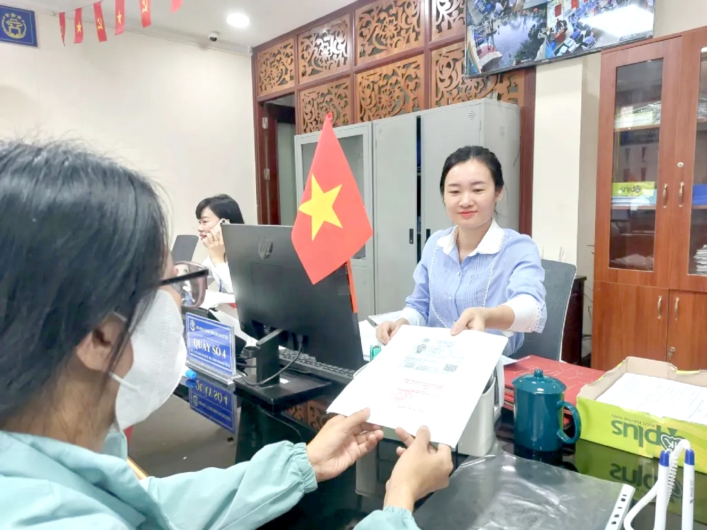 Chuyên viên hành chính công TP Hà Nội trả kết quả cho công dân. Ảnh Công Phương