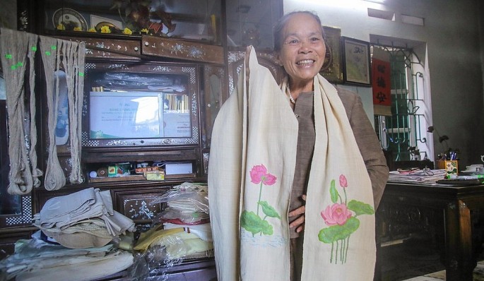 Nghệ nhân ưu tú Phan Thị Thuận với sản phẩm khăn lụa tơ sen. Ảnh NVCC